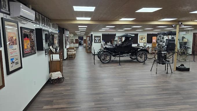 Interior of the Once Upon a Time in America Museum showing a Model T, antique projector, and gallery walls